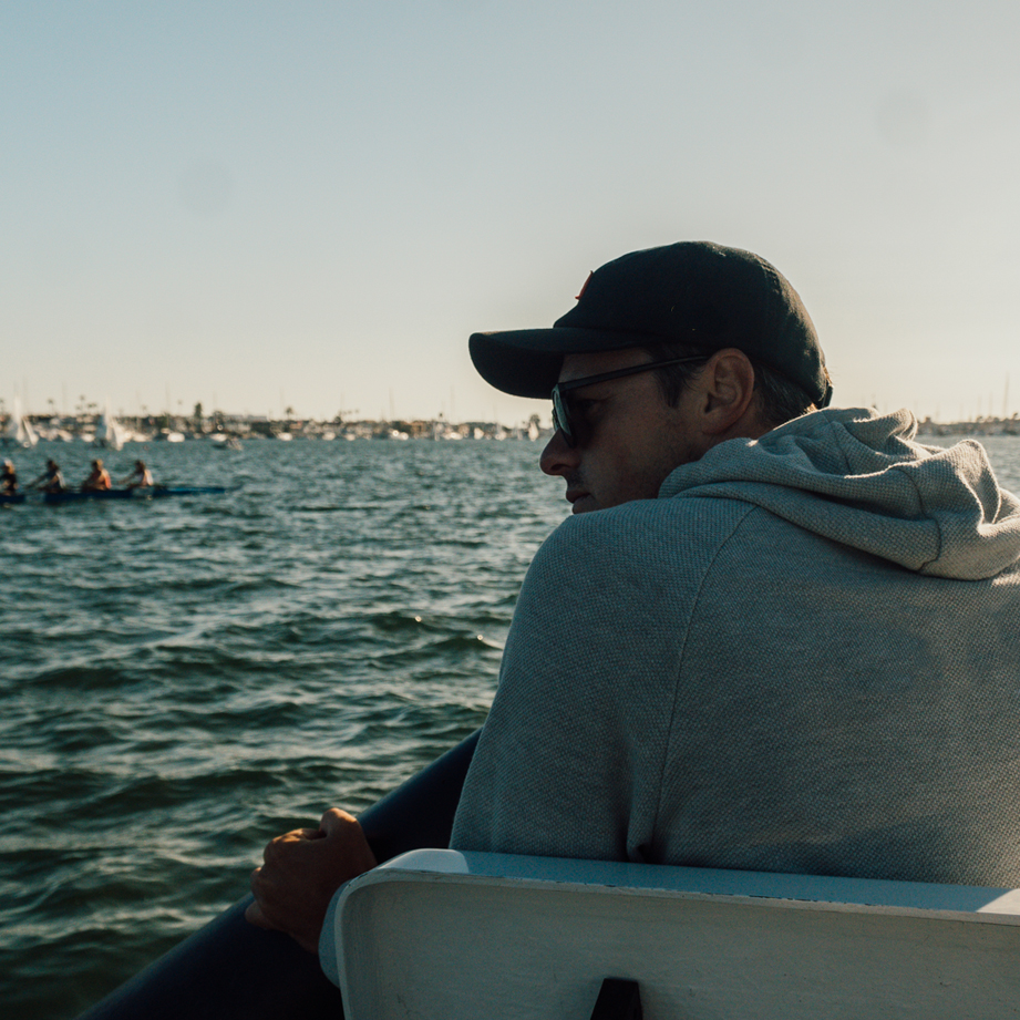 NAC Rowing Coach with his rowing crew, on a marina.