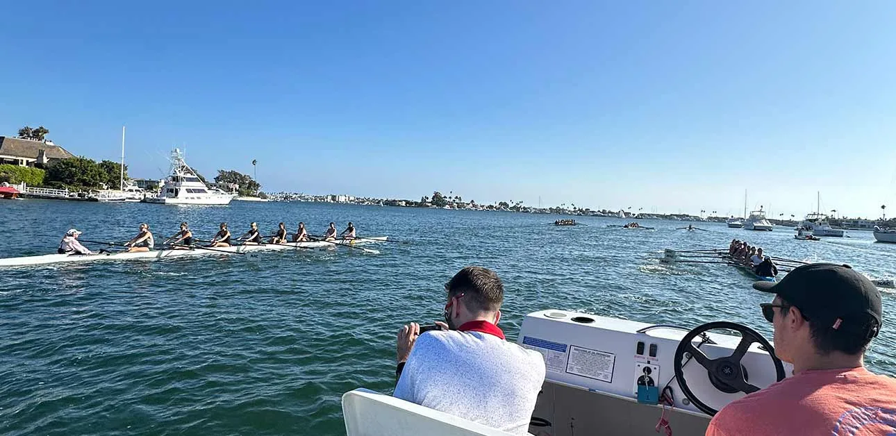 Leading-your-Assistant-Coaches Coach and assistant coach on a rowing launch
