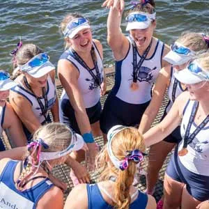 NAC Rowing Coach with his rowing crew, on a marina.