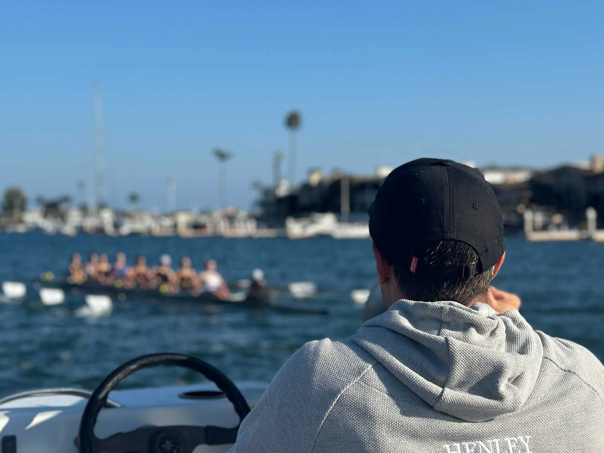 Rowing coach riding on a launch and coaching an eight